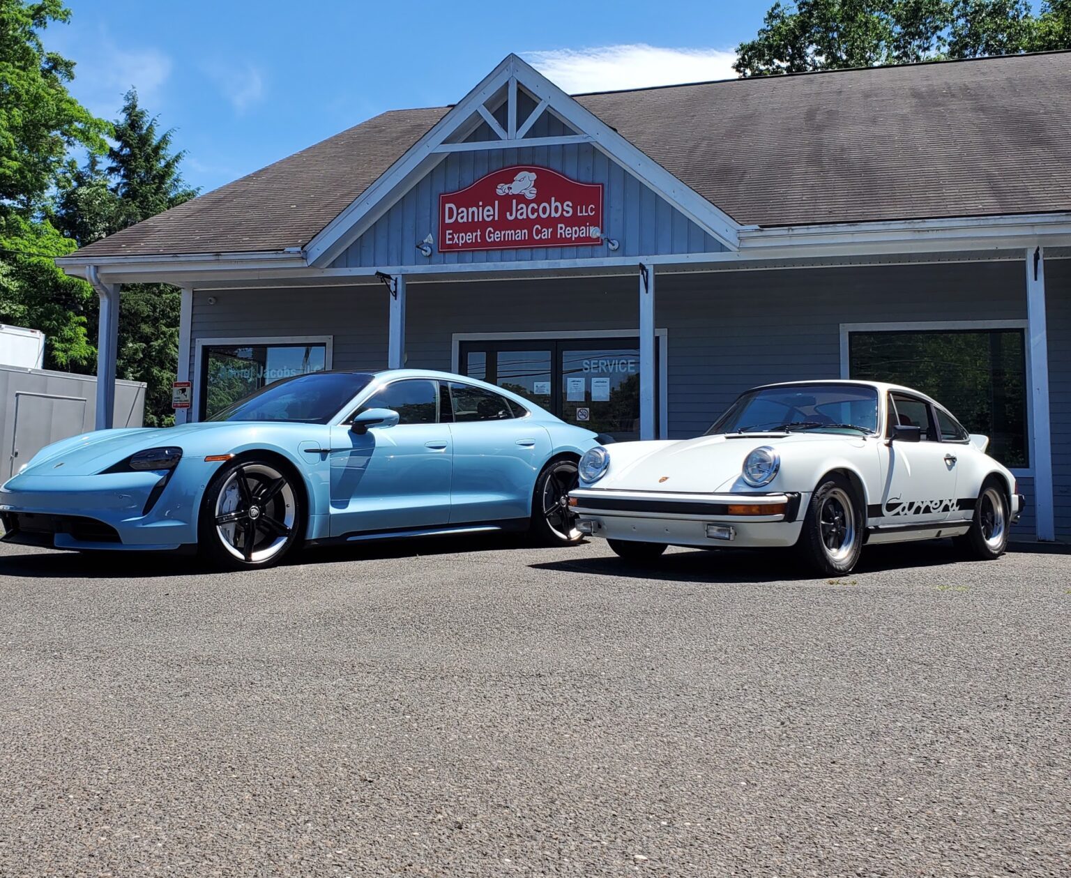 Two European cars parked outside the Daniel Jacobs Garage service bay in Southbury, Connecticut